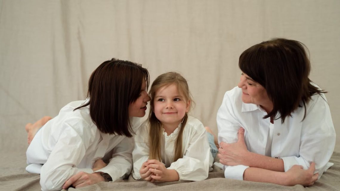 Three generations of women smiling together, symbolizing familial love and connection.